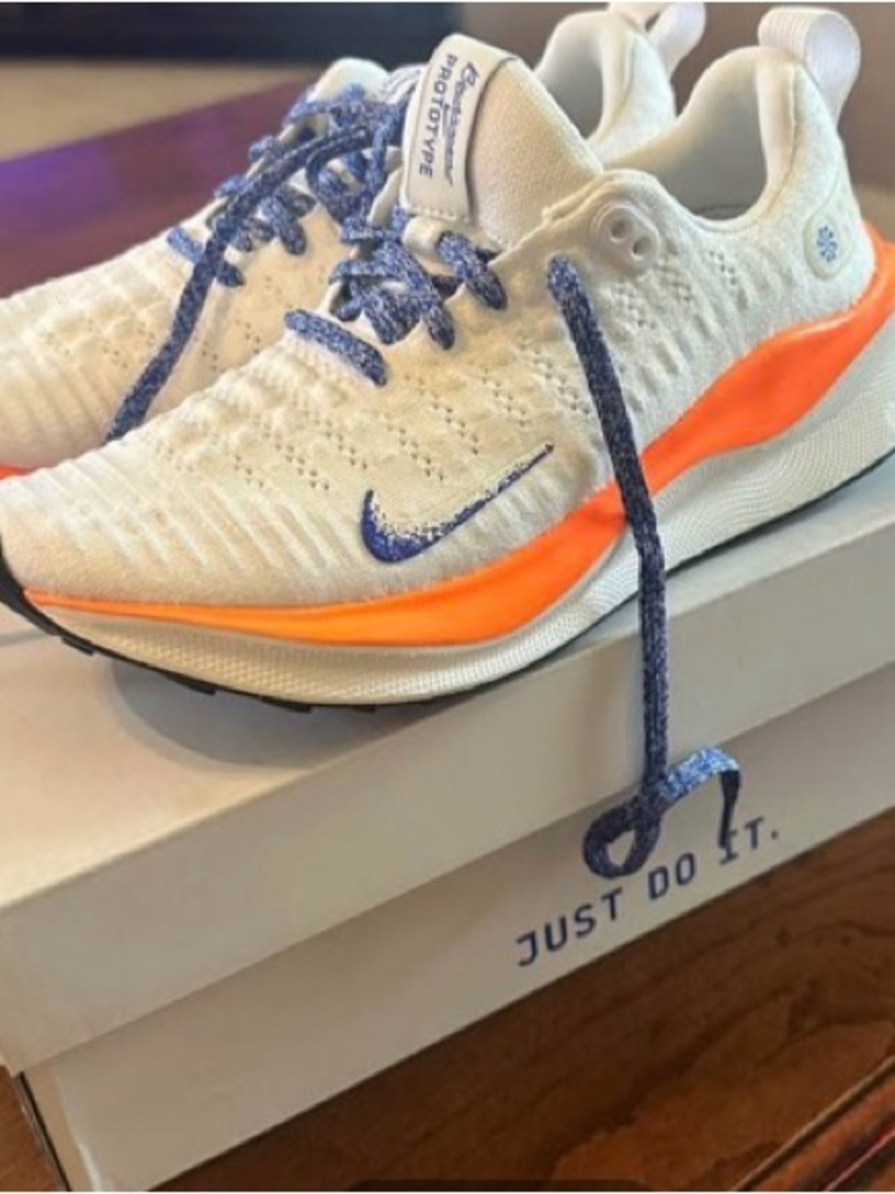 Nike White Sneakers with Orange Midsole and Blue Accents
